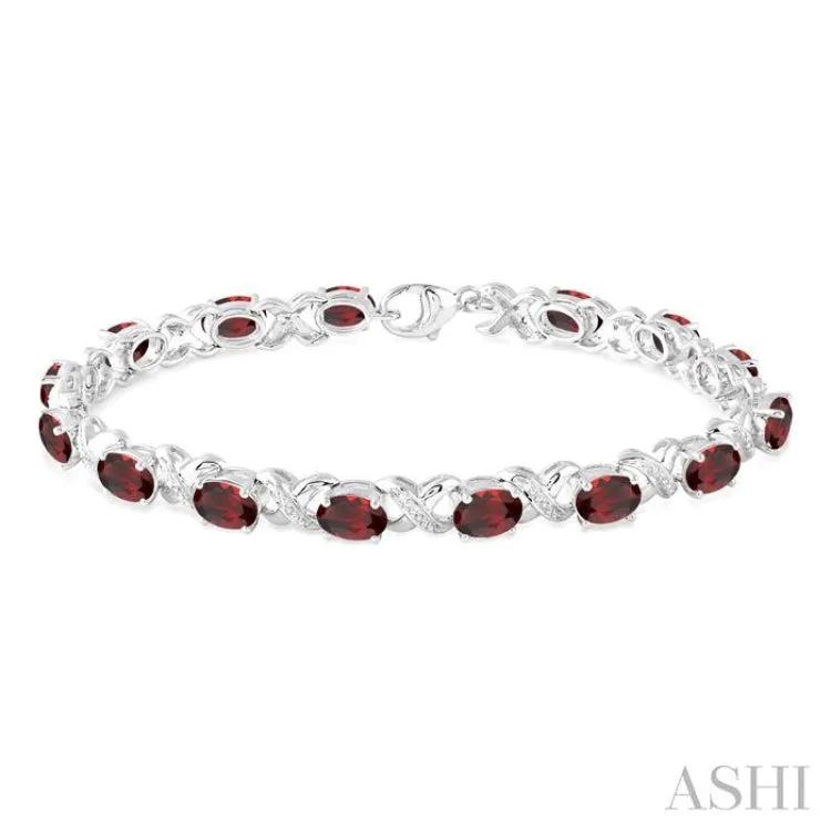 7x5 mm Oval Cut Garnet and 1/20 Ctw Round Cut Diamond Fashion Bracelet in Sterling Silver